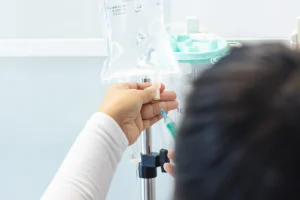 Medical professional preparing Athletix IV drip infusion