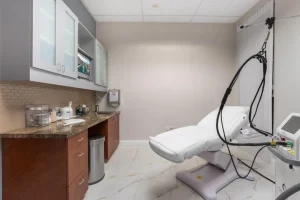 Modern treatment room with equipment for body contouring at Parie Med Spa