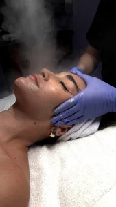 Facial steam and treatment being applied to client at Parie Med Spa