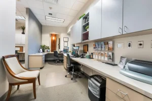 Office workspace at Parie Med Spa with modern desks and promotional materials