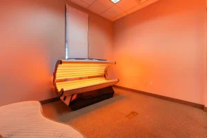 Red light therapy bed in private treatment room at Parie Med Spa