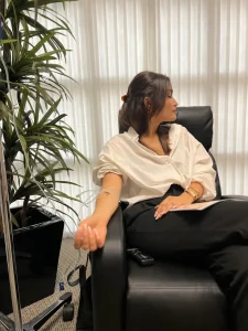 Client receiving SlimDrip IV therapy infusion in wellness clinic