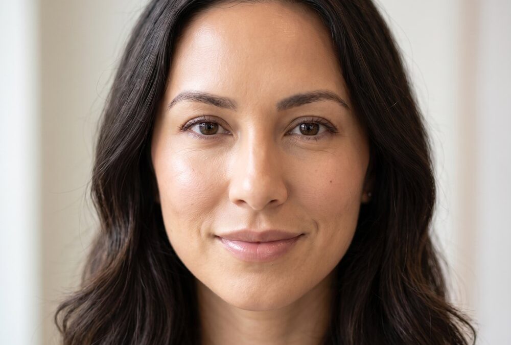 Close portrait of a woman's face in soft natural light, model image